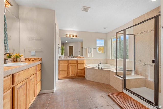 bathroom featuring vanity, separate shower and tub, and tile patterned flooring