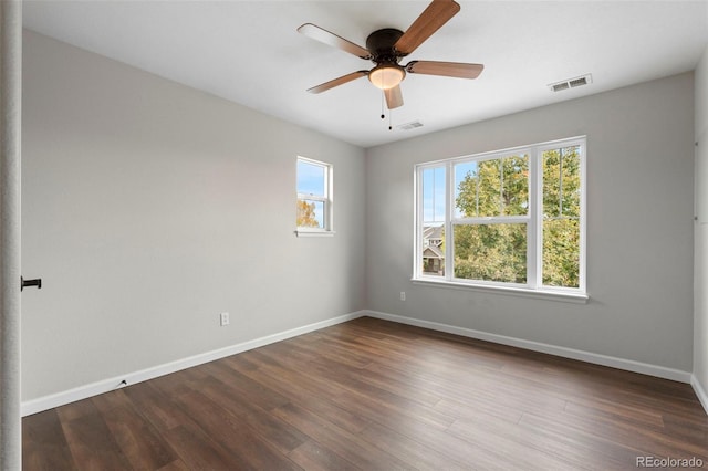 spare room featuring ceiling fan and dark hardwood / wood-style flooring