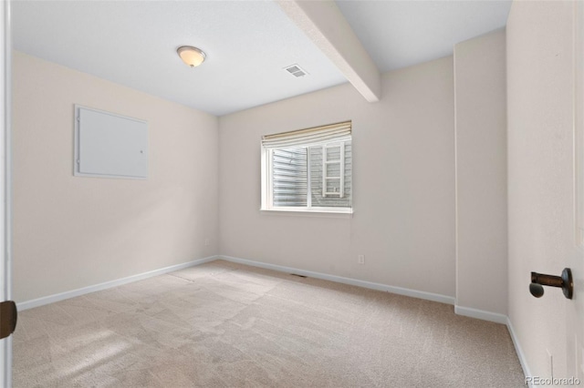 carpeted empty room featuring beam ceiling