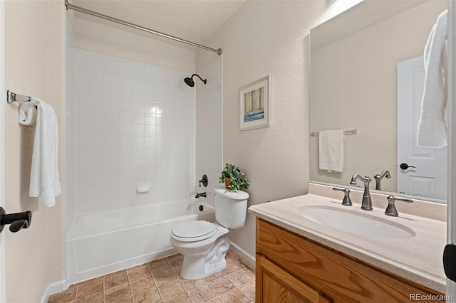 full bathroom featuring vanity, tiled shower / bath combo, and toilet