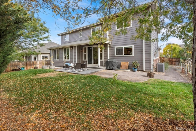 back of property featuring central air condition unit, a patio area, and a lawn