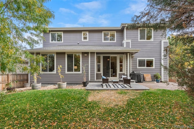 back of house featuring a yard and a patio area