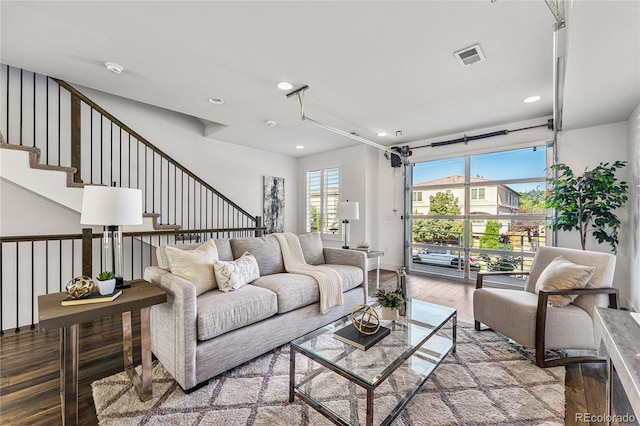 living area featuring light wood-style floors, visible vents, stairway, and recessed lighting