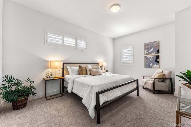 carpeted bedroom featuring baseboards