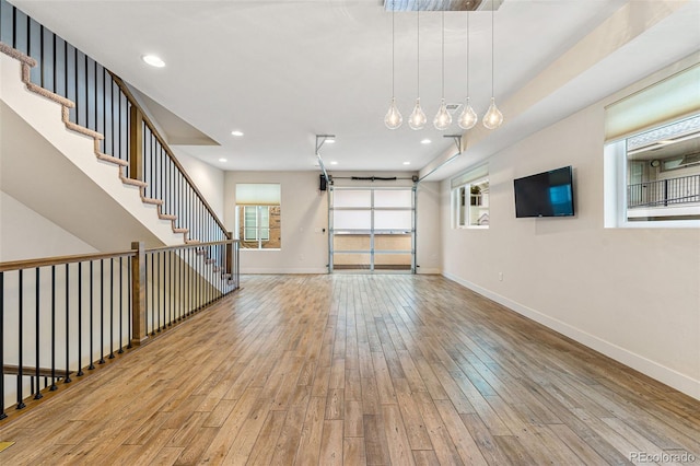 unfurnished living room featuring light wood finished floors, recessed lighting, and baseboards