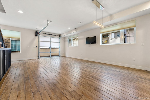 garage with recessed lighting, visible vents, and baseboards