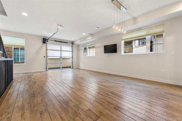 garage with baseboards and recessed lighting