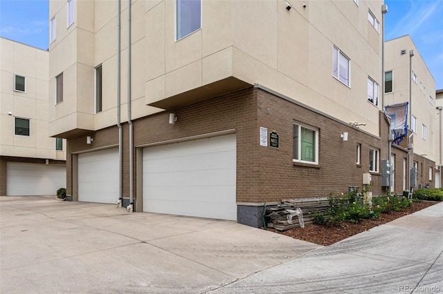 view of home's exterior with brick siding and an attached garage