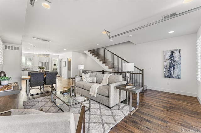 living area featuring stairs, visible vents, wood finished floors, and recessed lighting