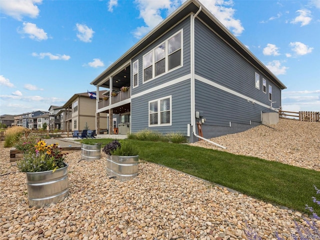 rear view of property featuring a balcony