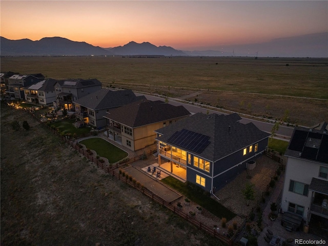 aerial view at dusk with a mountain view and a rural view