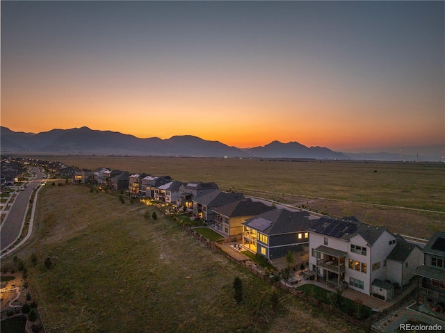 aerial view at dusk featuring a mountain view