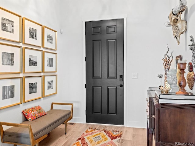 entrance foyer with light wood finished floors and baseboards