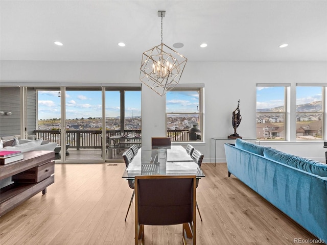 dining area featuring recessed lighting, a healthy amount of sunlight, and light wood-style flooring