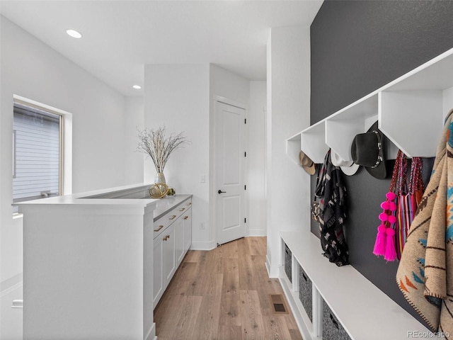 mudroom with visible vents, baseboards, light wood-style flooring, and recessed lighting