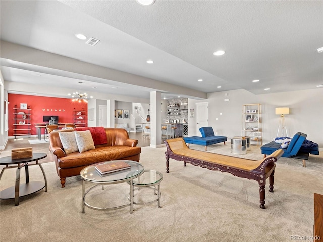 carpeted living area featuring recessed lighting, visible vents, and a textured ceiling