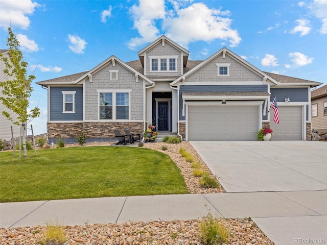 craftsman inspired home featuring a garage, driveway, a front lawn, and stone siding