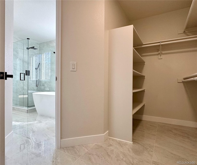 spacious closet with marble finish floor