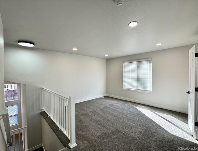 carpeted spare room featuring recessed lighting and baseboards