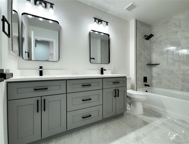 full bathroom with visible vents, toilet, double vanity, marble finish floor, and a sink