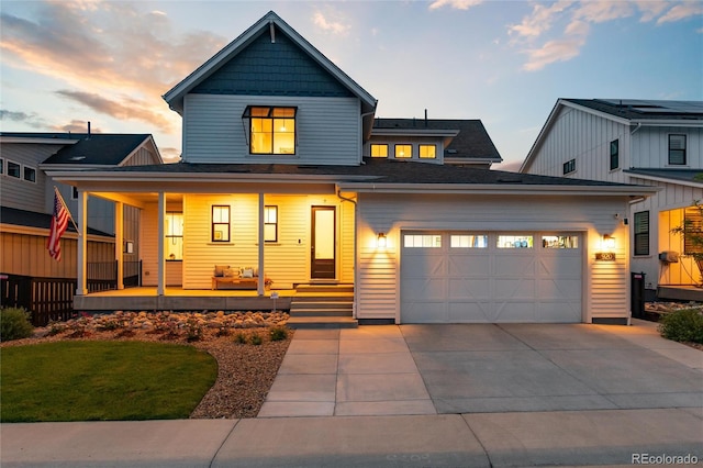 view of front of property with covered porch and a garage