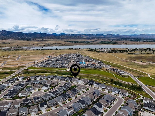 drone / aerial view with a water and mountain view