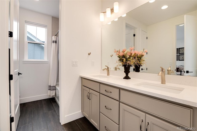 bathroom featuring shower / bath combo with shower curtain, vanity, and hardwood / wood-style flooring