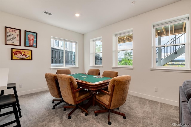 dining space featuring light colored carpet