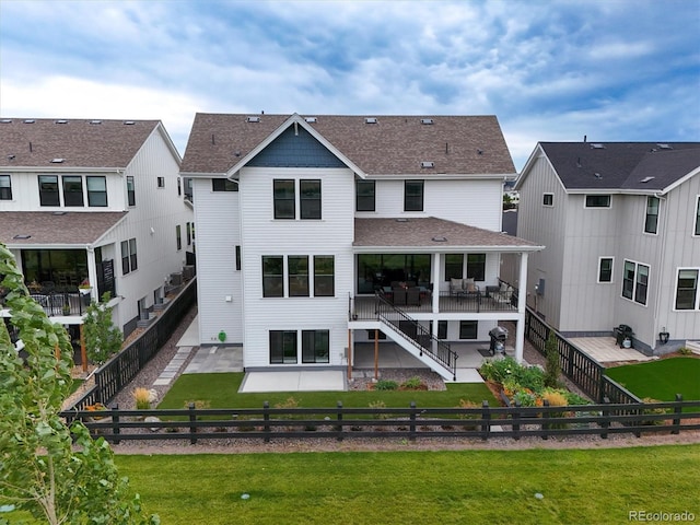 back of property featuring a yard and a patio