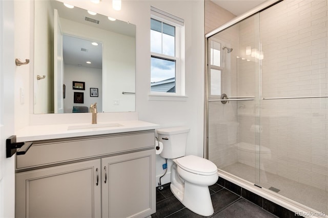 bathroom featuring tile patterned floors, vanity, an enclosed shower, and toilet