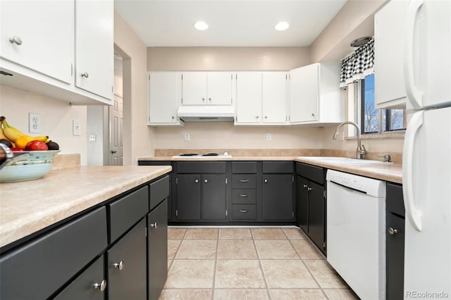 kitchen featuring white cabinetry, sink, light tile patterned flooring, and white appliances