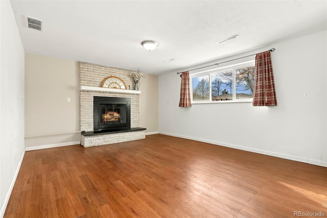 unfurnished living room with hardwood / wood-style flooring and a fireplace