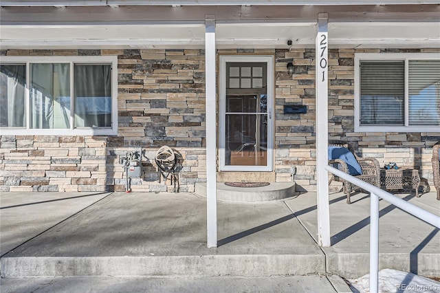 property entrance with stone siding