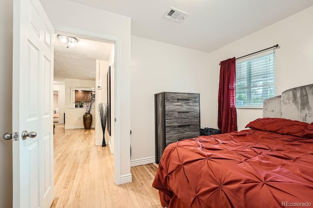 bedroom with light hardwood / wood-style floors