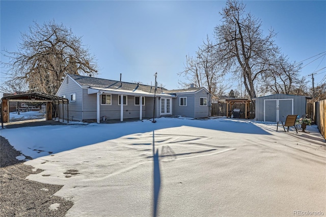 view of front of home featuring a carport and a storage unit