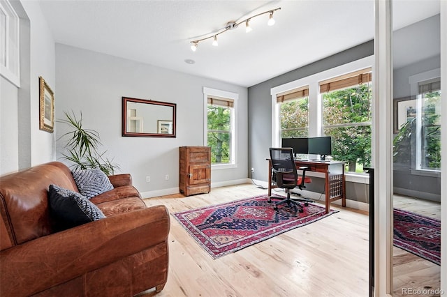 8276 E 28th Dr, Denver, CO 80238 - office area with wood finished floors and baseboards