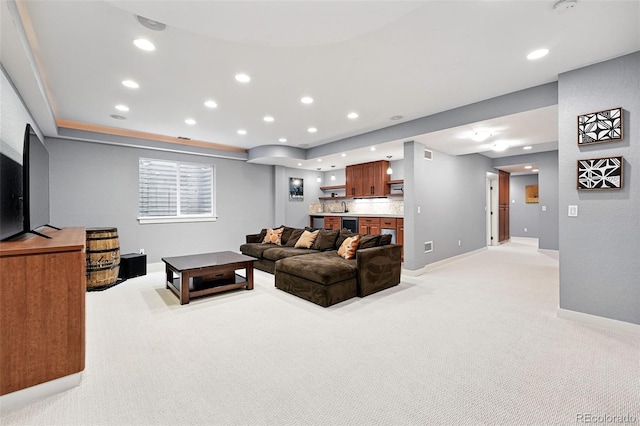 8276 E 28th Dr, Denver, CO 80238 - living area with light colored carpet, baseboards, recessed lighting, beverage cooler, and a tray ceiling