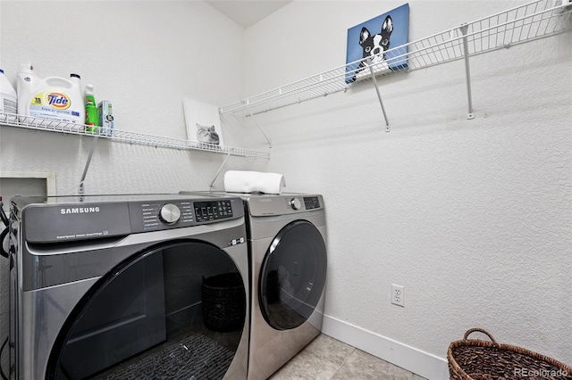 8276 E 28th Dr, Denver, CO 80238 - laundry area featuring separate washer and dryer, baseboards, and a textured wall