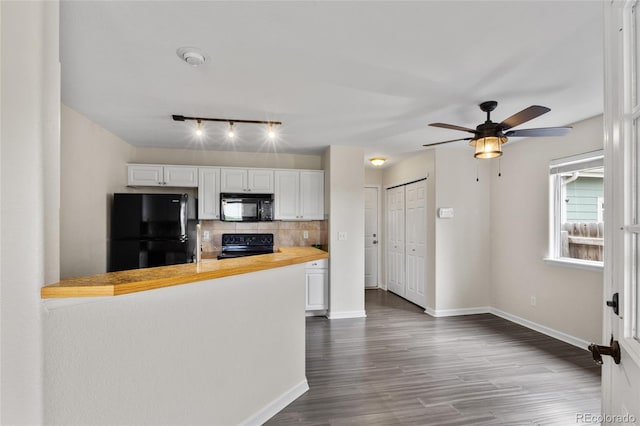 kitchen with black appliances, track lighting, dark wood finished floors, backsplash, and white cabinets