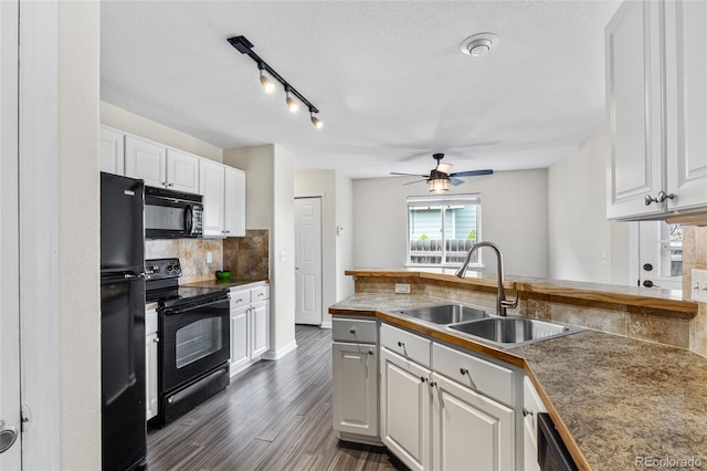 kitchen featuring black appliances, a sink, white cabinets, a ceiling fan, and tasteful backsplash
