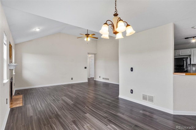 unfurnished living room with dark wood-type flooring, a chandelier, a ceiling fan, lofted ceiling, and baseboards