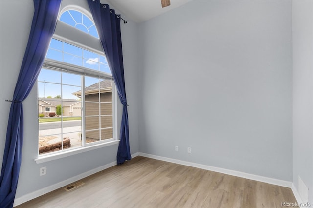 empty room with wood finished floors and baseboards
