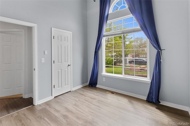 unfurnished bedroom with wood finished floors and baseboards