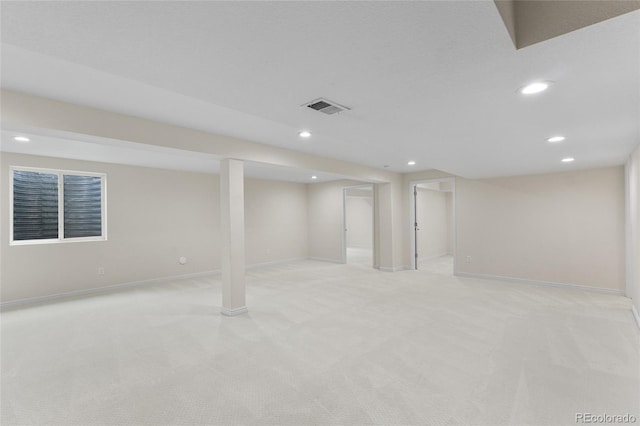 finished basement featuring recessed lighting, light carpet, and baseboards