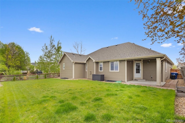 rear view of property featuring a patio area, central air condition unit, and a shingled roof
