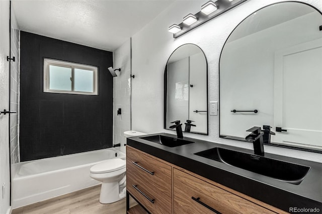 1000 Worchester St, Aurora, CO 80011 - bathroom with double vanity, wood finished floors, and bathtub / shower combination