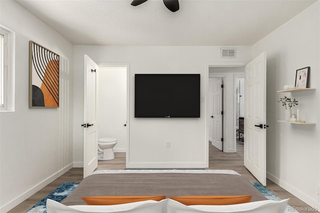 1000 Worchester St, Aurora, CO 80011 - bedroom with wood finished floors, ensuite bath, and ceiling fan