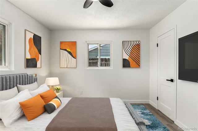 1000 Worchester St, Aurora, CO 80011 - bedroom featuring wood finished floors, a ceiling fan, and a textured ceiling