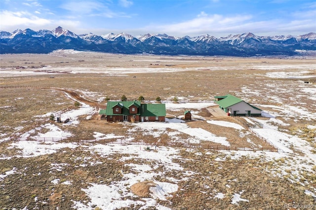 snowy aerial view featuring a mountain view