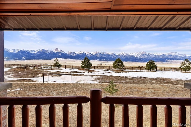 snowy yard with a mountain view and a rural view